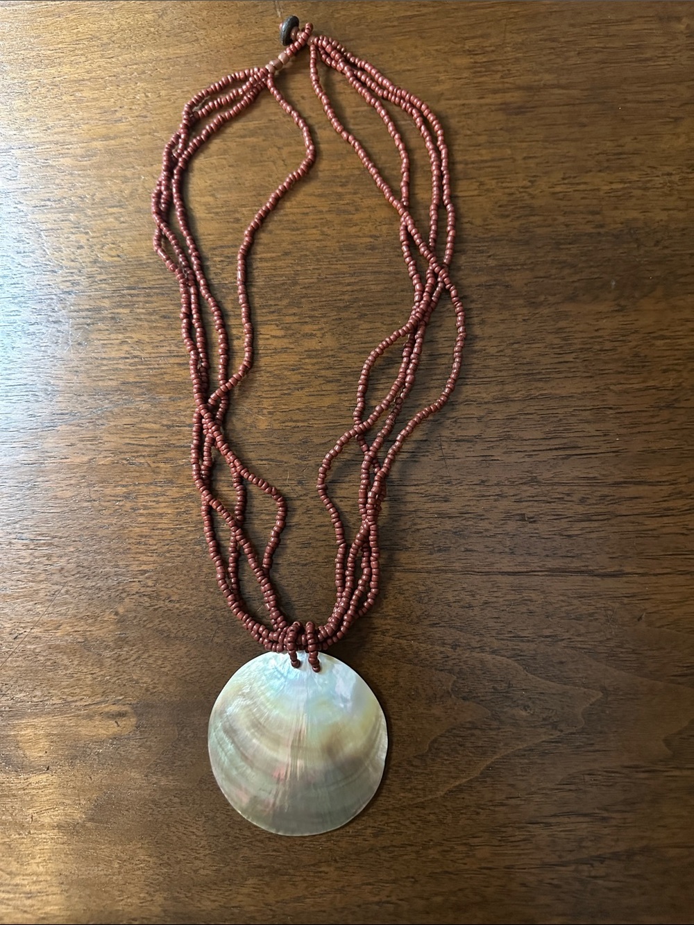 Multi-Strand Red Beaded Necklace with Iridescent Shell Pendant